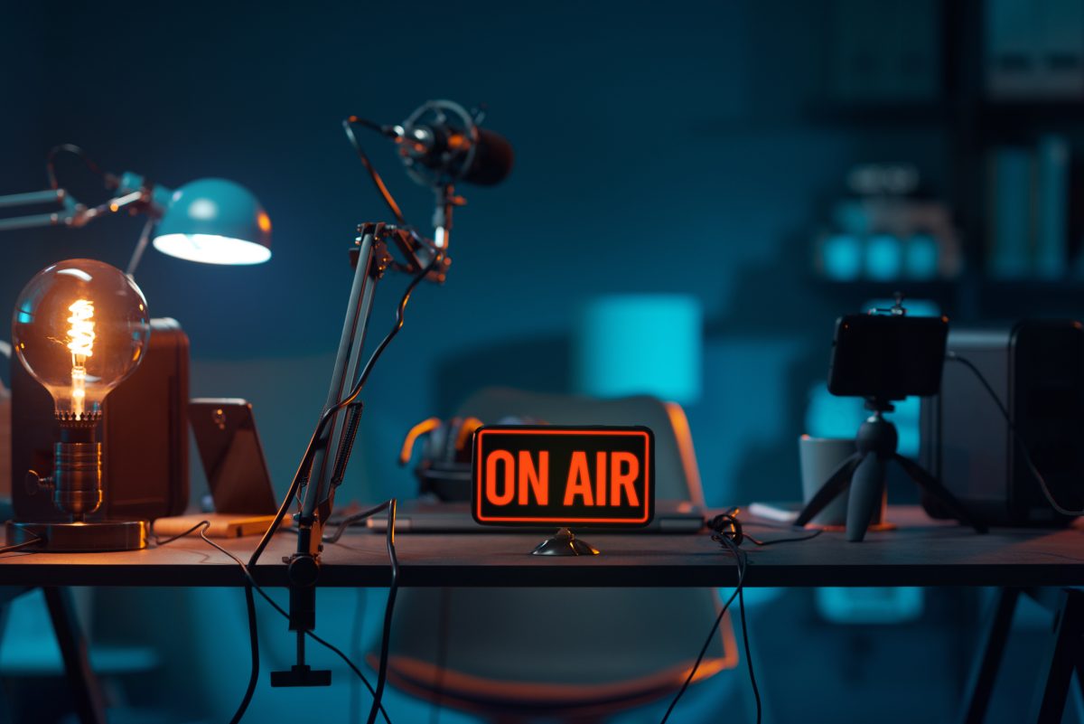 On Air sign on a desk with audio equipment