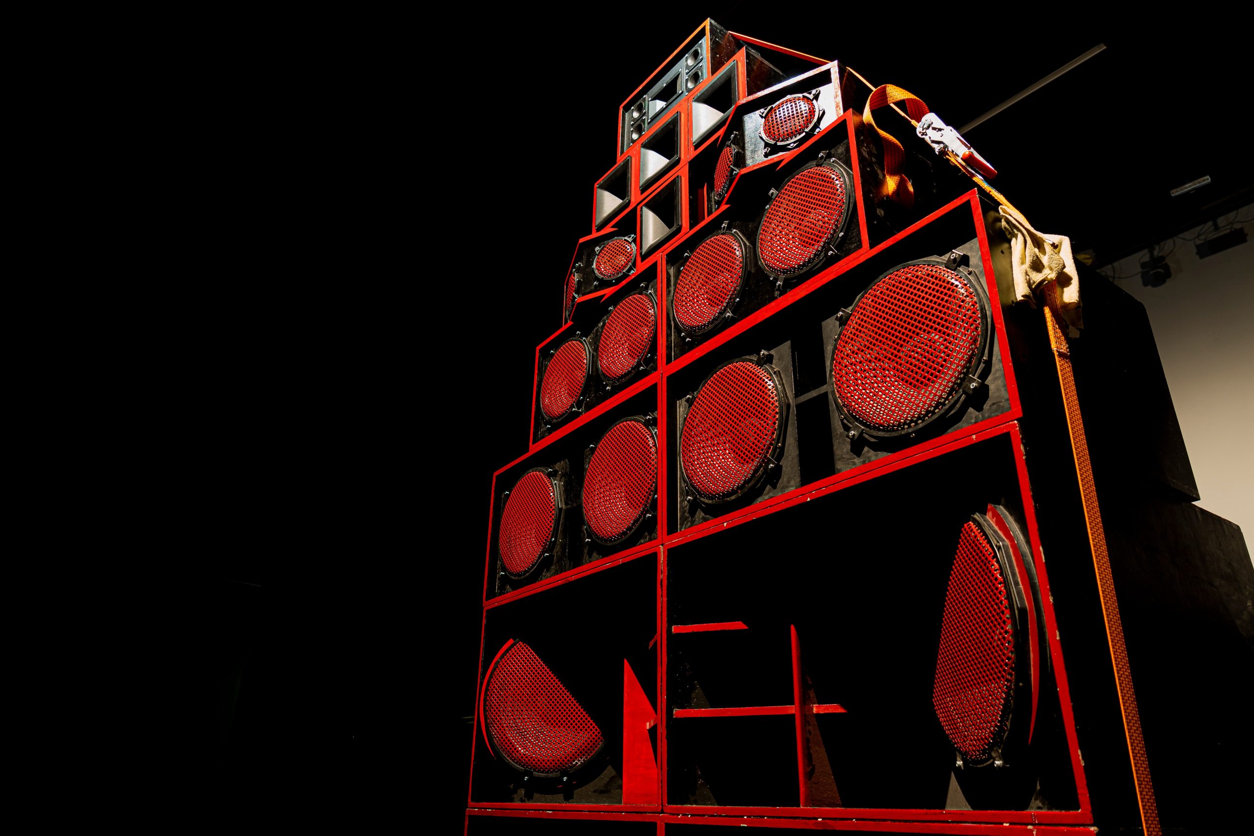 A stack of red and black speakers